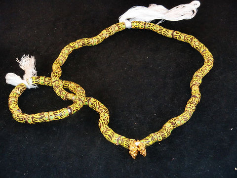 Brown w/hand-painted yellow lines, green dots & golden accents; on string / tie-on; neck beads approx. 25" long; wrist beads approx. 10 1/2" long.