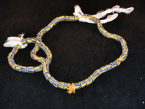 Blue w/hand-painted orange, white lines & golden accents; on string / tie-on; neck beads approx. 25" long; wrist beads approx. 10 1/2" long.