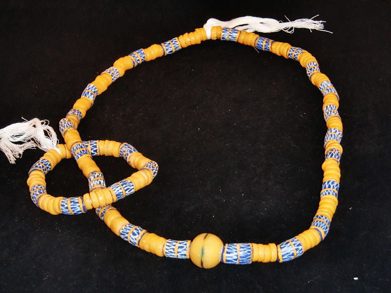 Blue w/beige spacer beads, hand-painted beige designs & accent stone; on string / tie-on; neck beads approx. 36" long; wrist beads approx. 11" long.